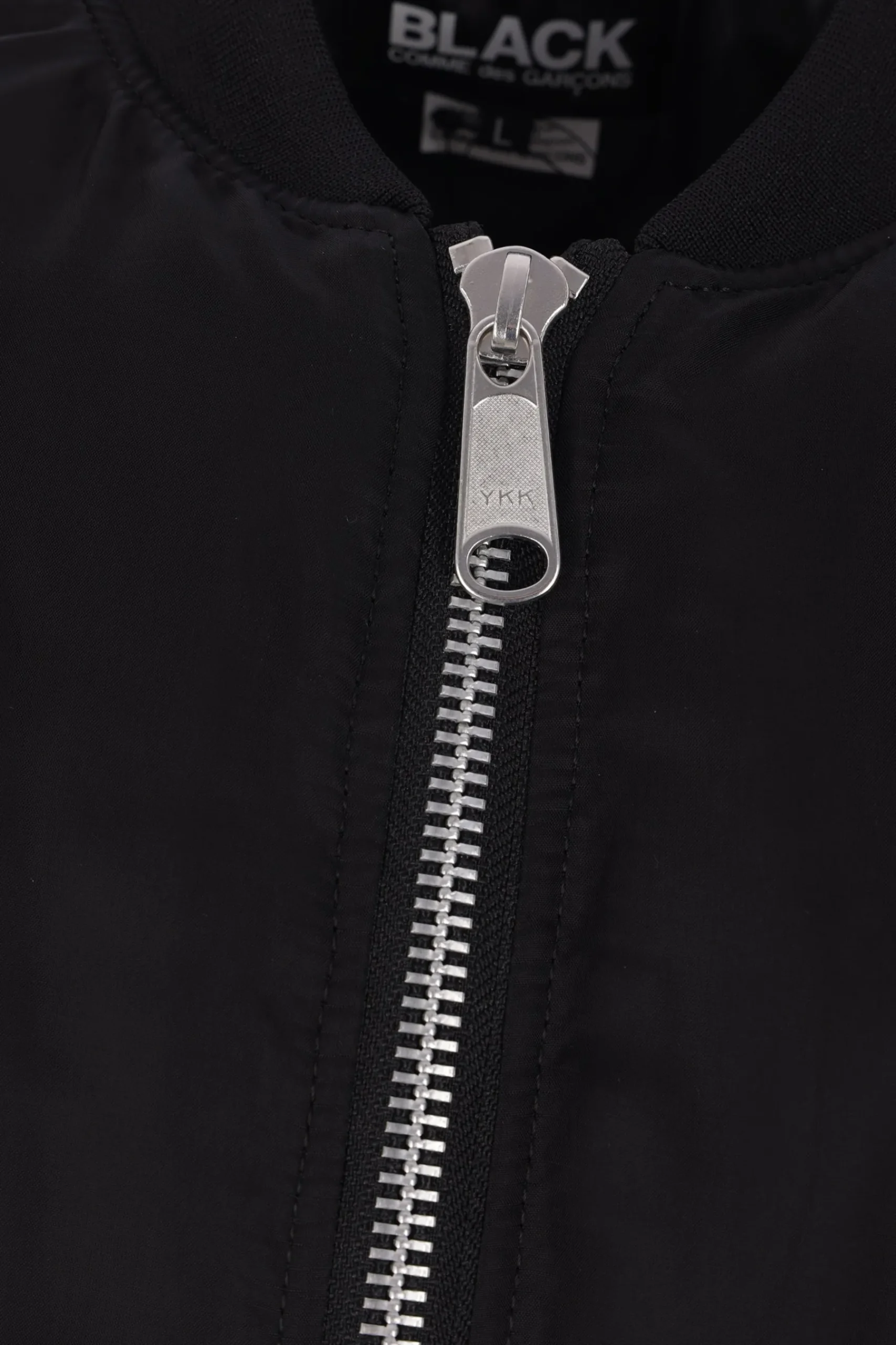 BLACK COMME des GARÇONS reversible asymmetrical bomber jacket.